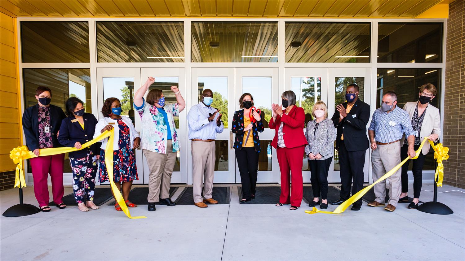 People cutting the ribbon at Conn Magnet Elementary Ribbon Cutting Ceremony.
