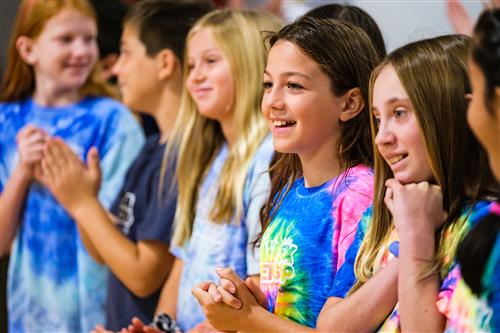 Students applaud as the ribbon is cut to celebrate the opening of their new school