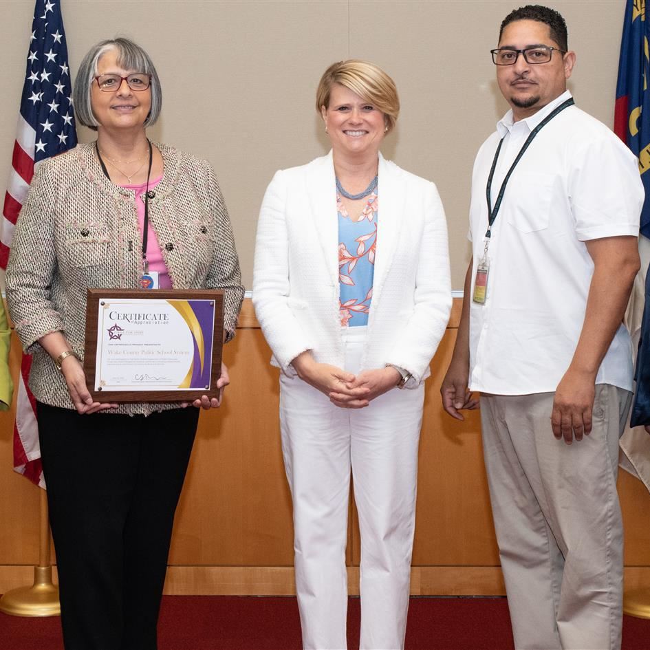 WCPSS representatives accepting purple star award