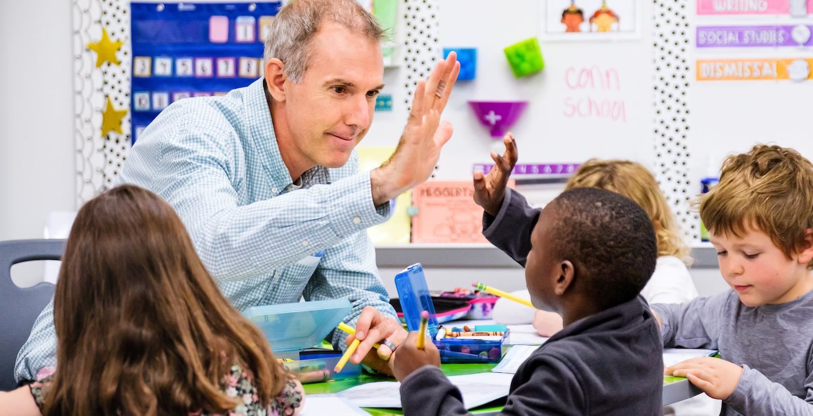 conn teacher high fives student