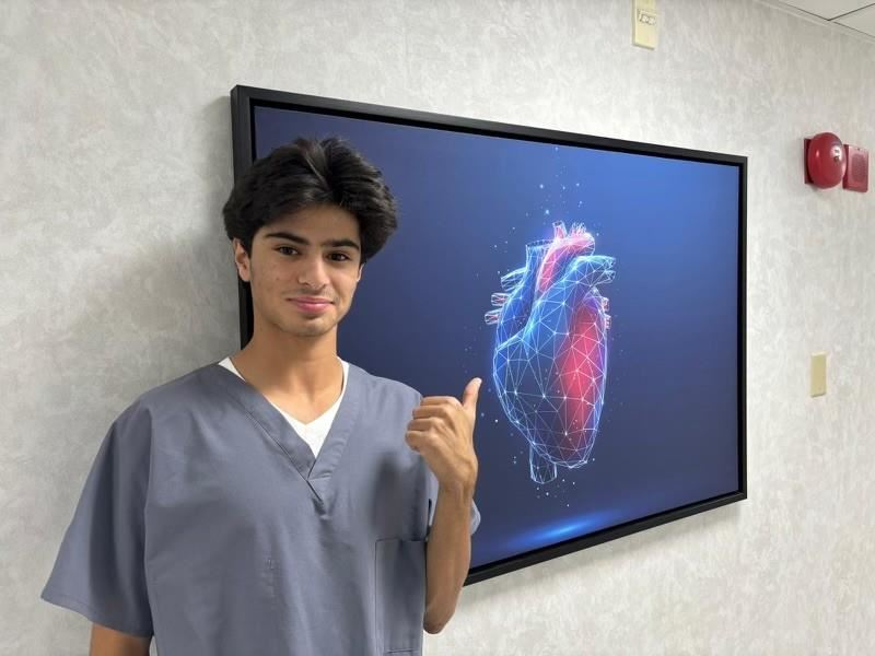Abdel points to a diagram of a heart
