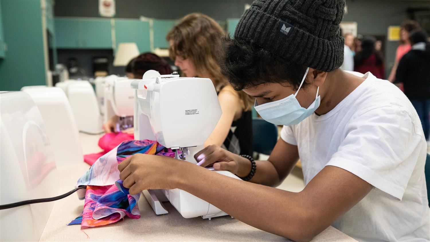 Photo of students sewing.