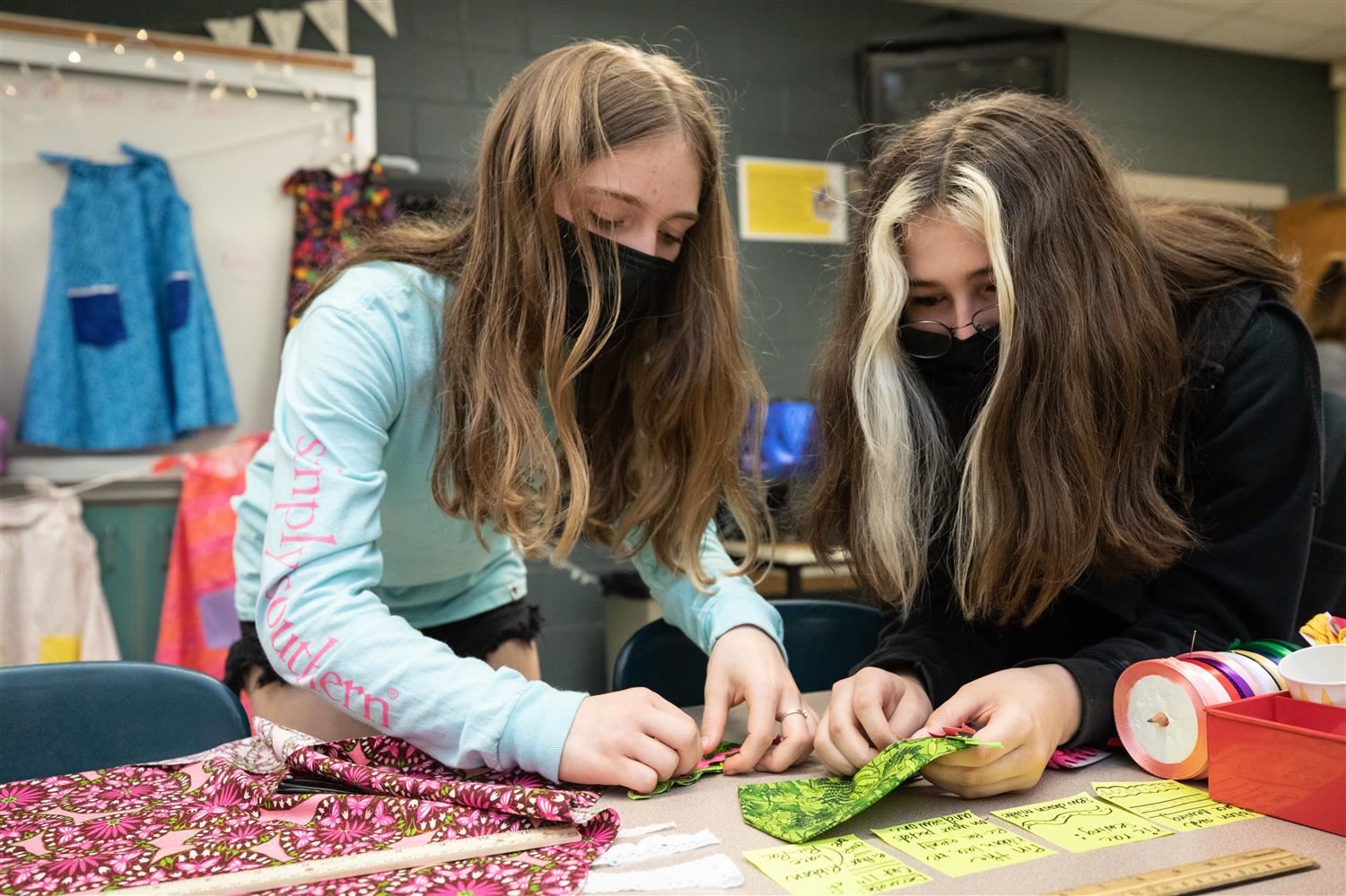 Photo of students making dresses.