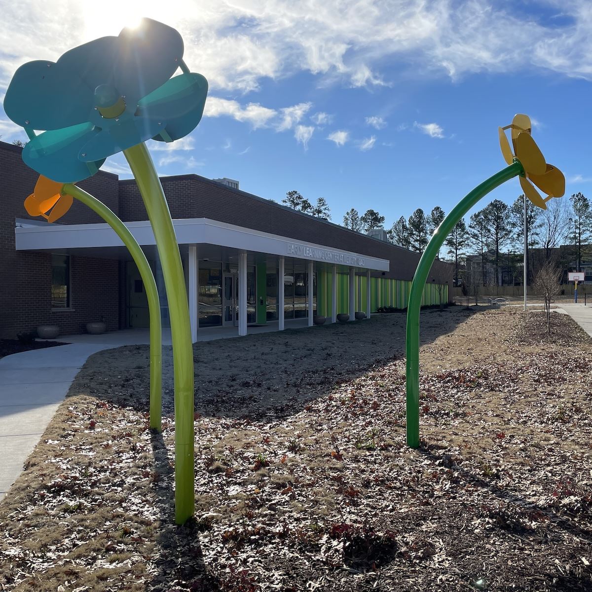  Exterior photo of the Early Learning Center with giant flower art piece