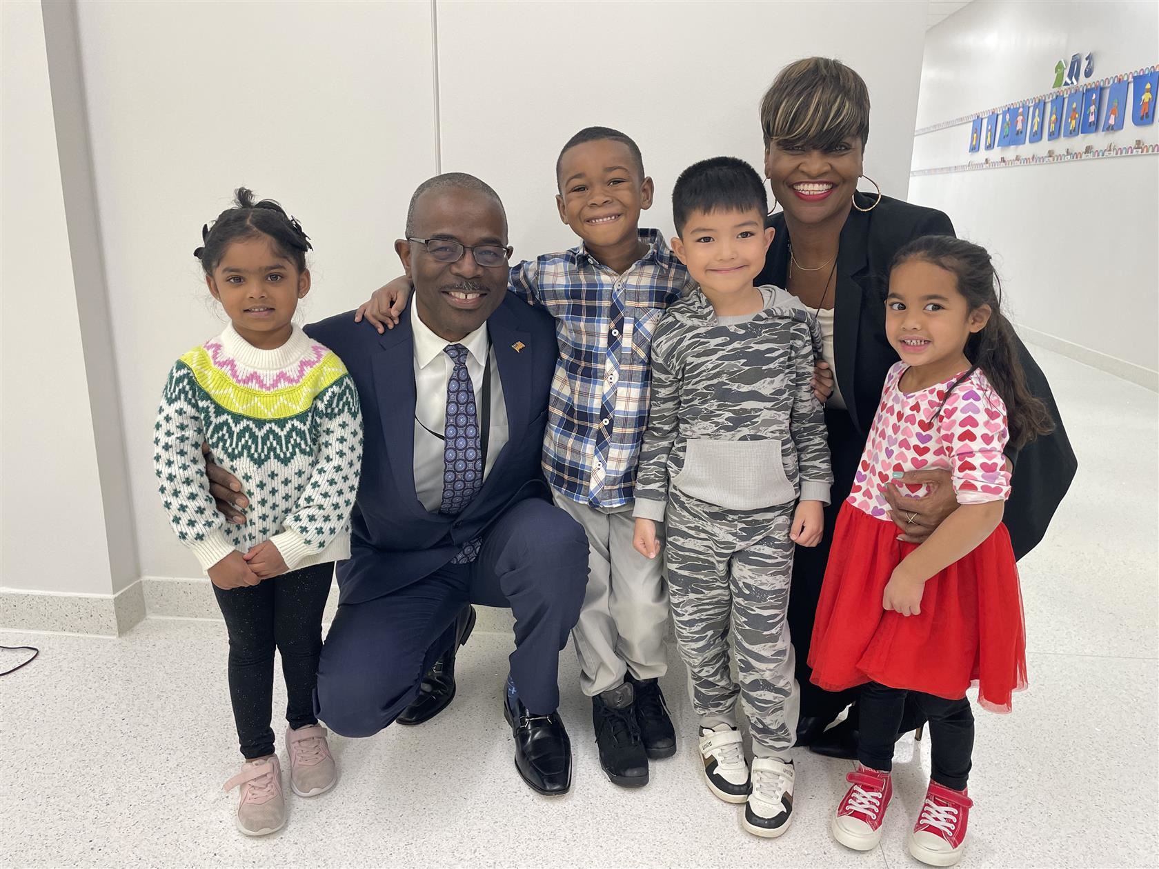 Dr. Taylor and Director Williams smile for a photo with several students