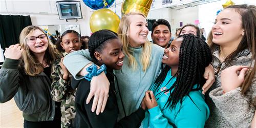 Dance teacher celebrating with students 