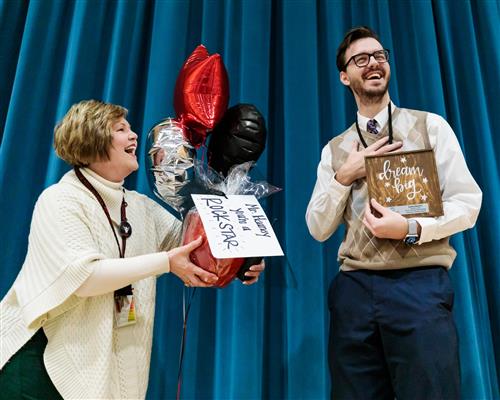 Teacher getting award from principal 