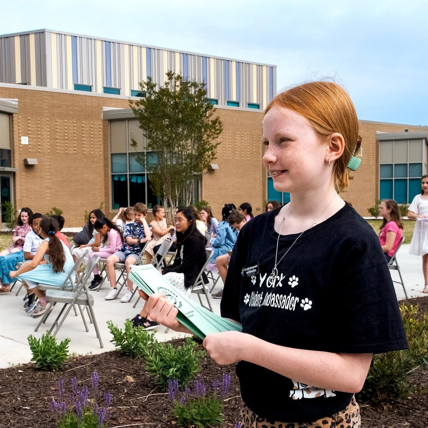  Photo of student holding programs.