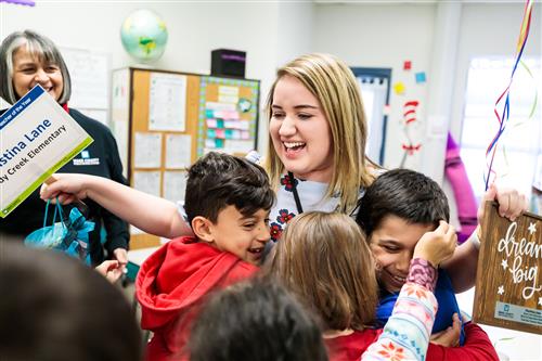 Teacher celebrating with students 