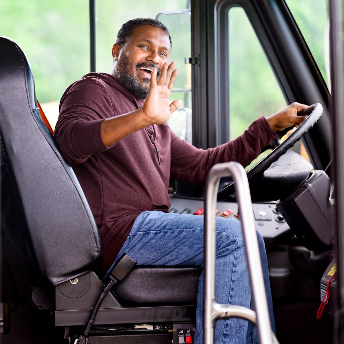  A bus driver waves to the camera