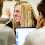 People smiling while using computers