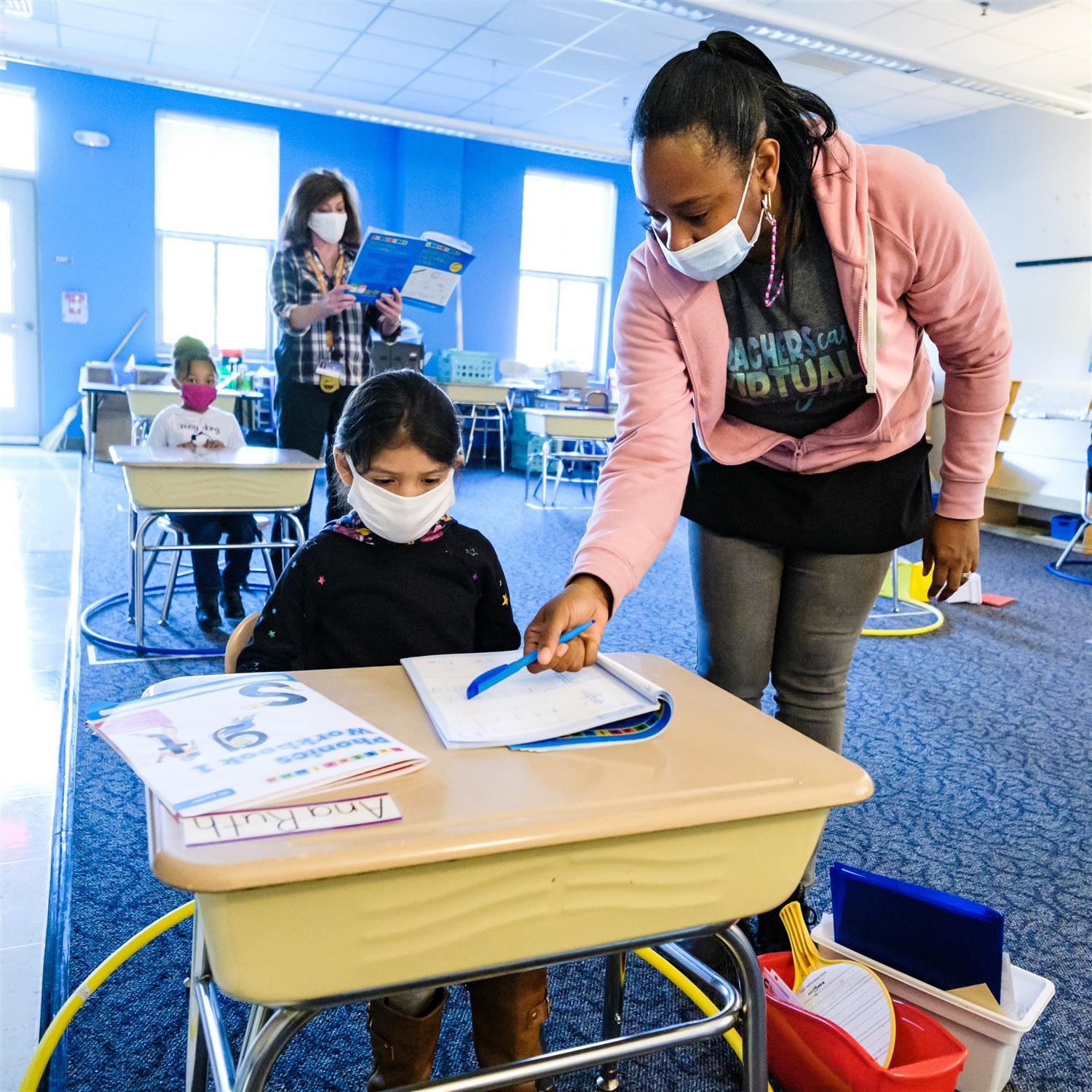  photo of teacher helping a student