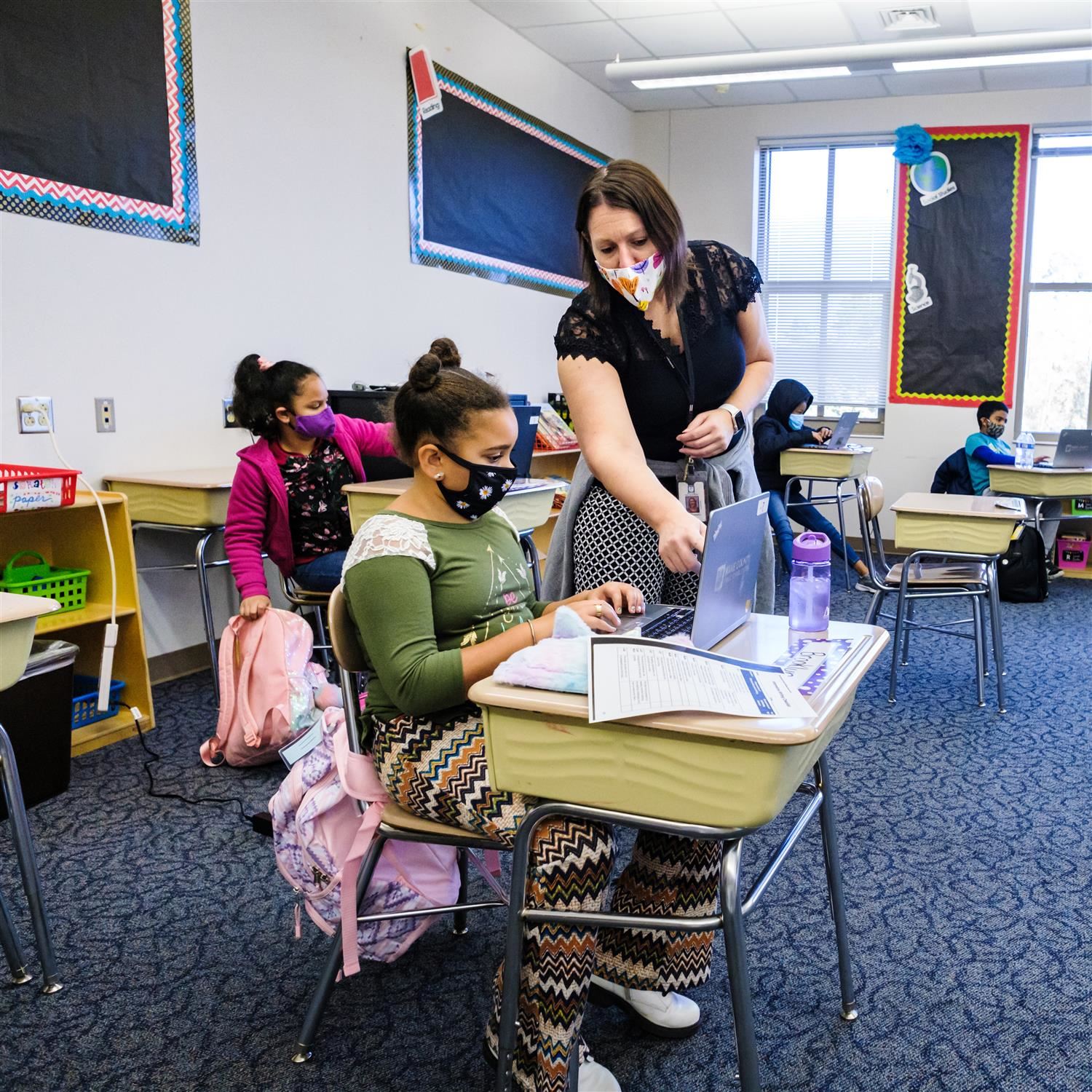  photo of teacher helping student