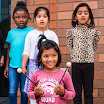  Kindergartners play music at the opening ceremony for their new school building