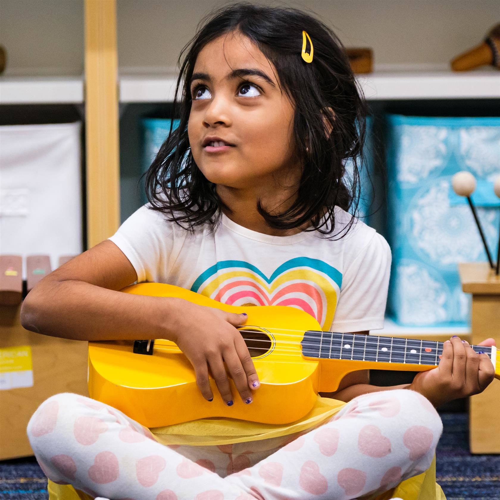  Student learns to play the ukulele