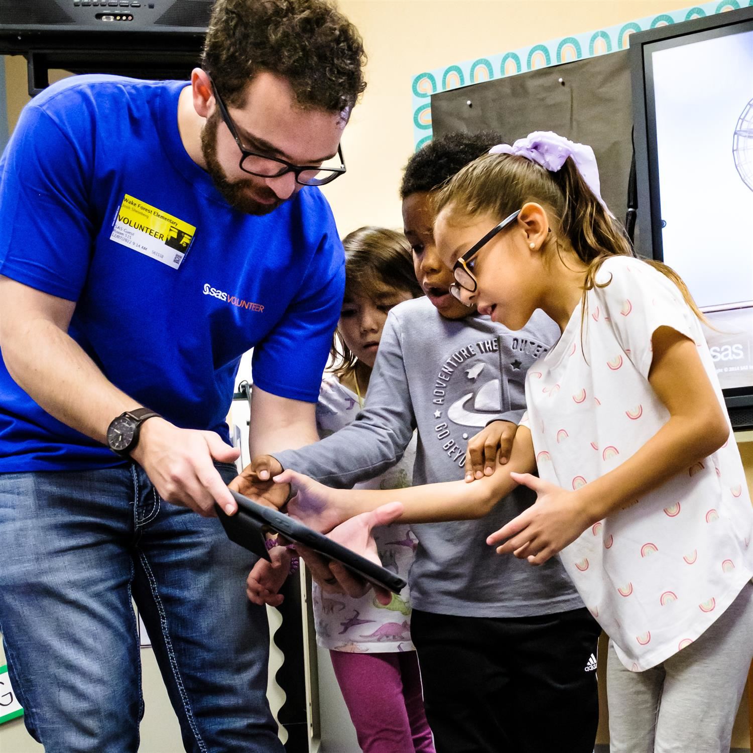  School volunteer showing off new technology to students