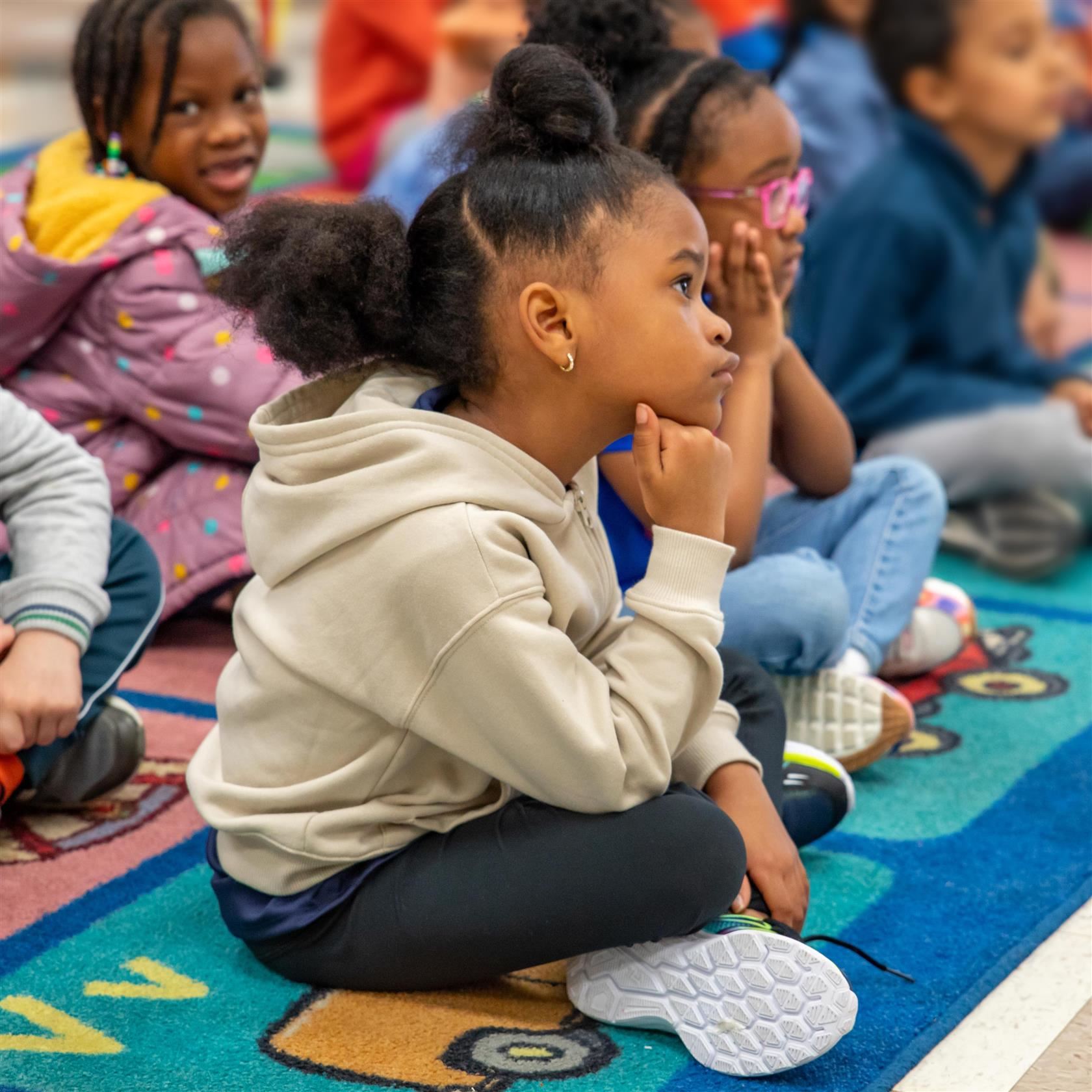  An elementary student focuses on listening during a lesson