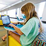  photo of student working on a laptop