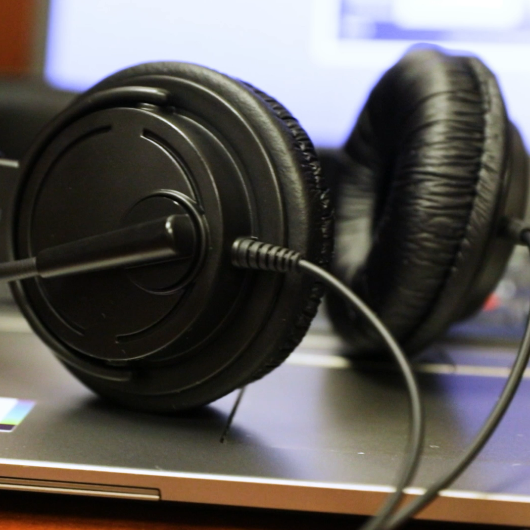  a pair of headphones in front of an english proficiency test