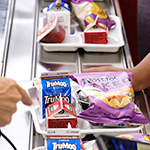  photo of lunch tray with chips, juice and milk