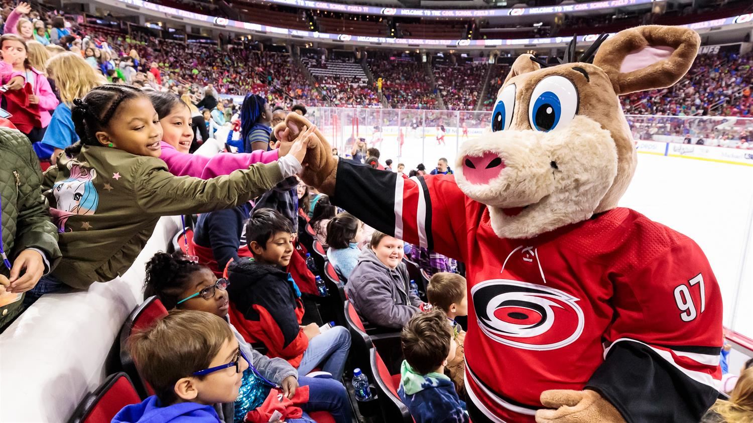 Carolina Hurricanes mascot Stormy high fives elementary students at PNC Arena 