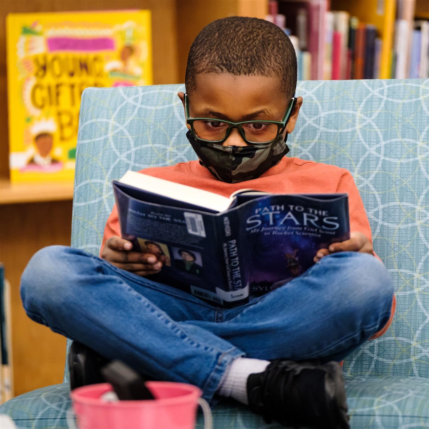  photo of boy reading a book