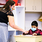  photo of teacher helping student