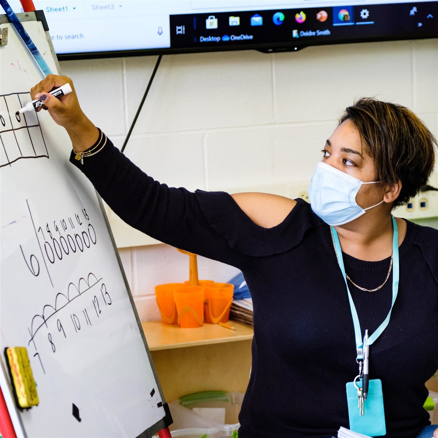  photo of teacher writing on board