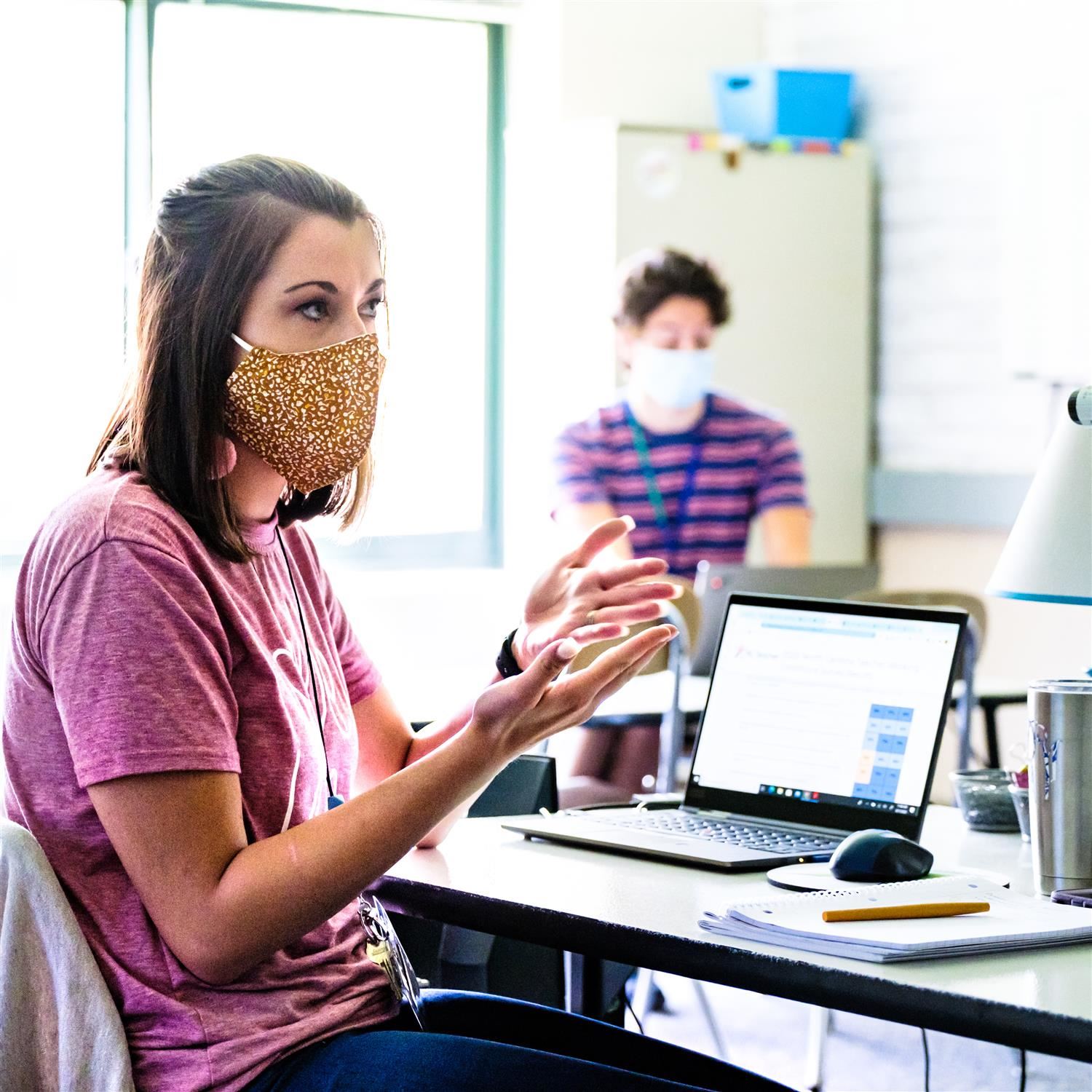  photo of teacher sitting in front of a laptop
