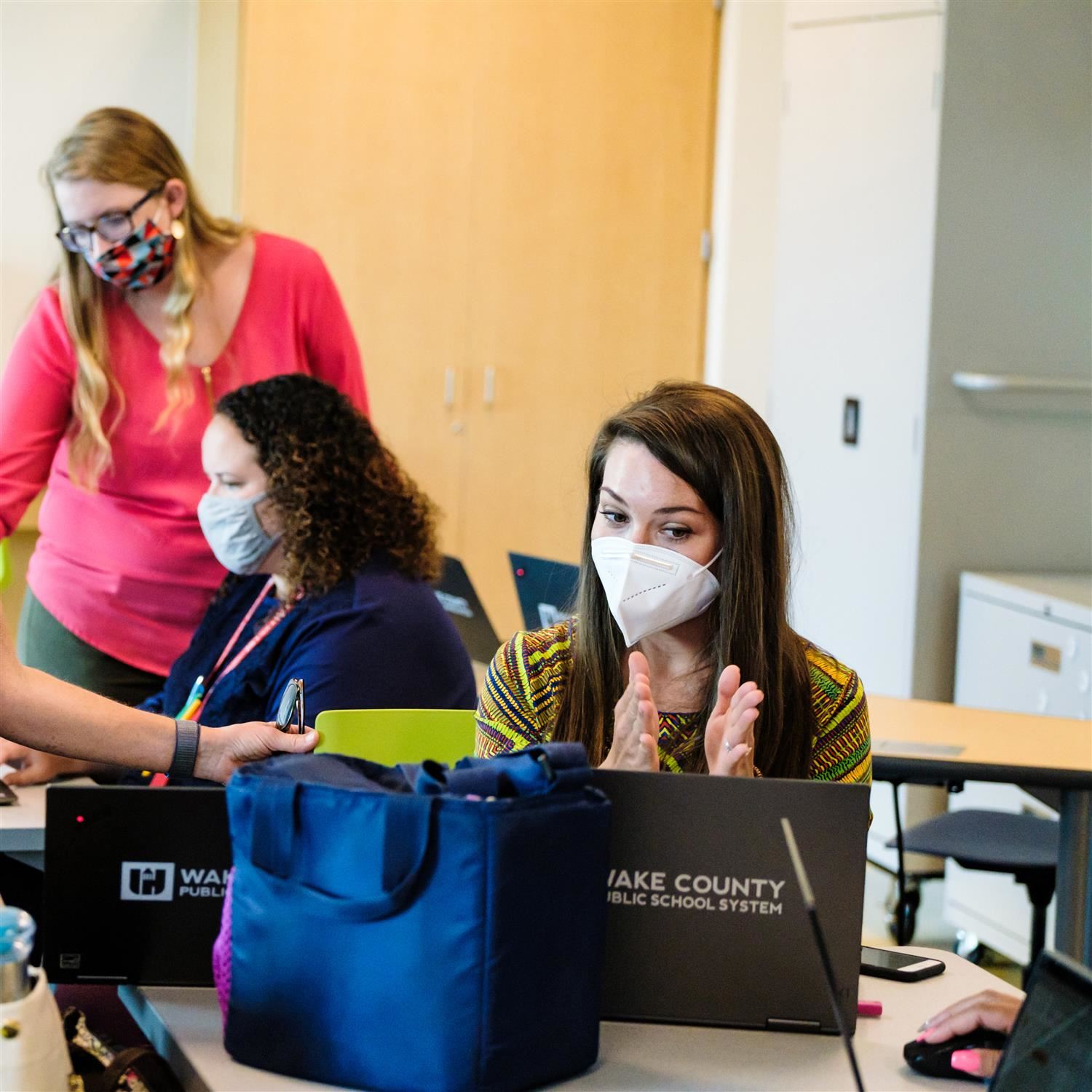 photo of teacher talking on a laptop 