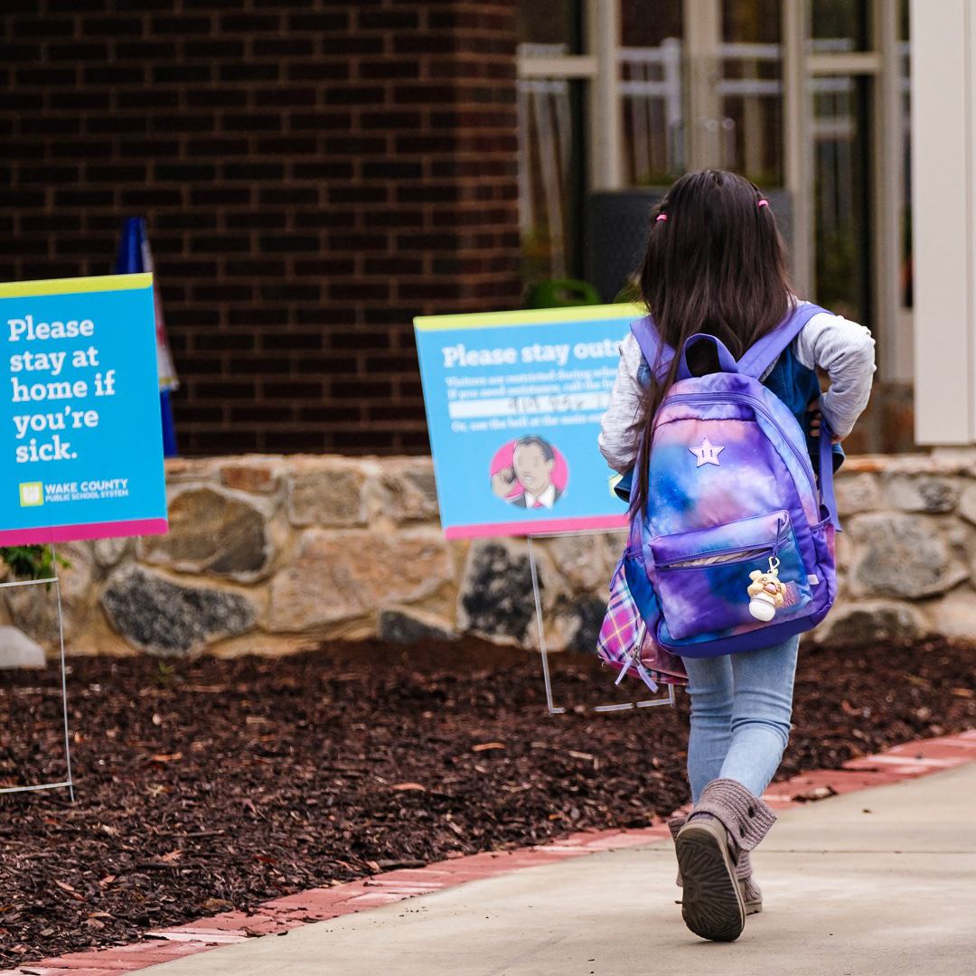  photo of student with backpack walking