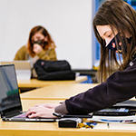  girl working on a laptop