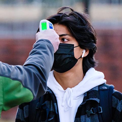  photo of student getting his temperature taken