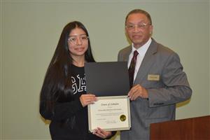 EWMHS Student holds a certificate from the Town of Zebulon standing beside Zebulon Mayor Glenn York