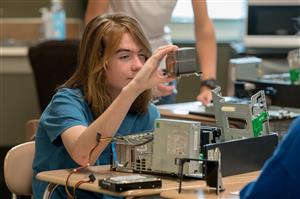 Student looking at computer parts 