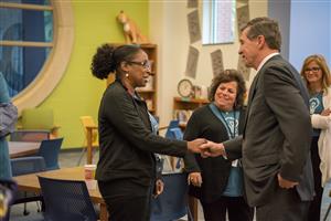 Governor Cooper shakes hands with Ms. Ferguson 