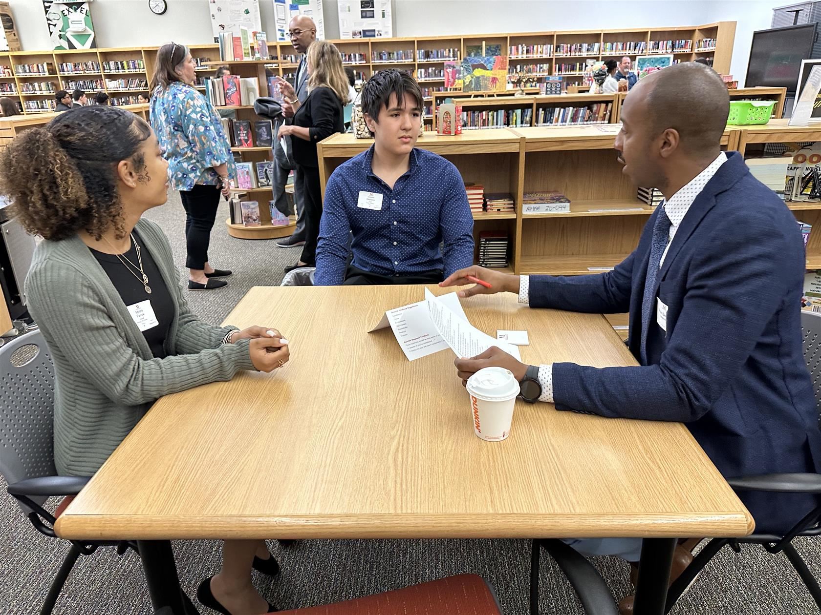 Students interviewing with business partners.