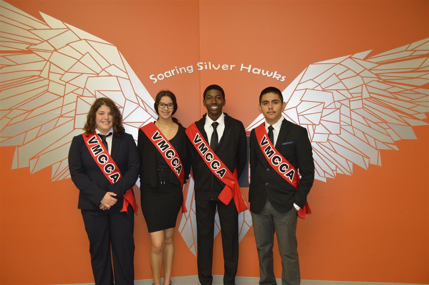Four student leaders dressed in business attire