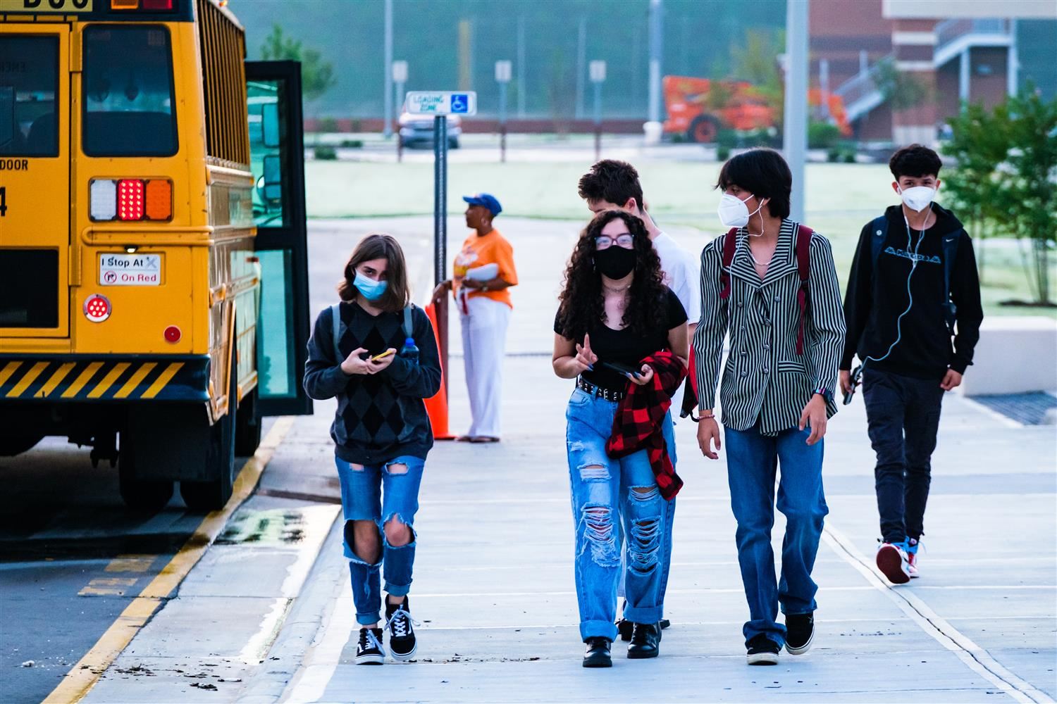 students wearing masks and walking students wearing masks and walking