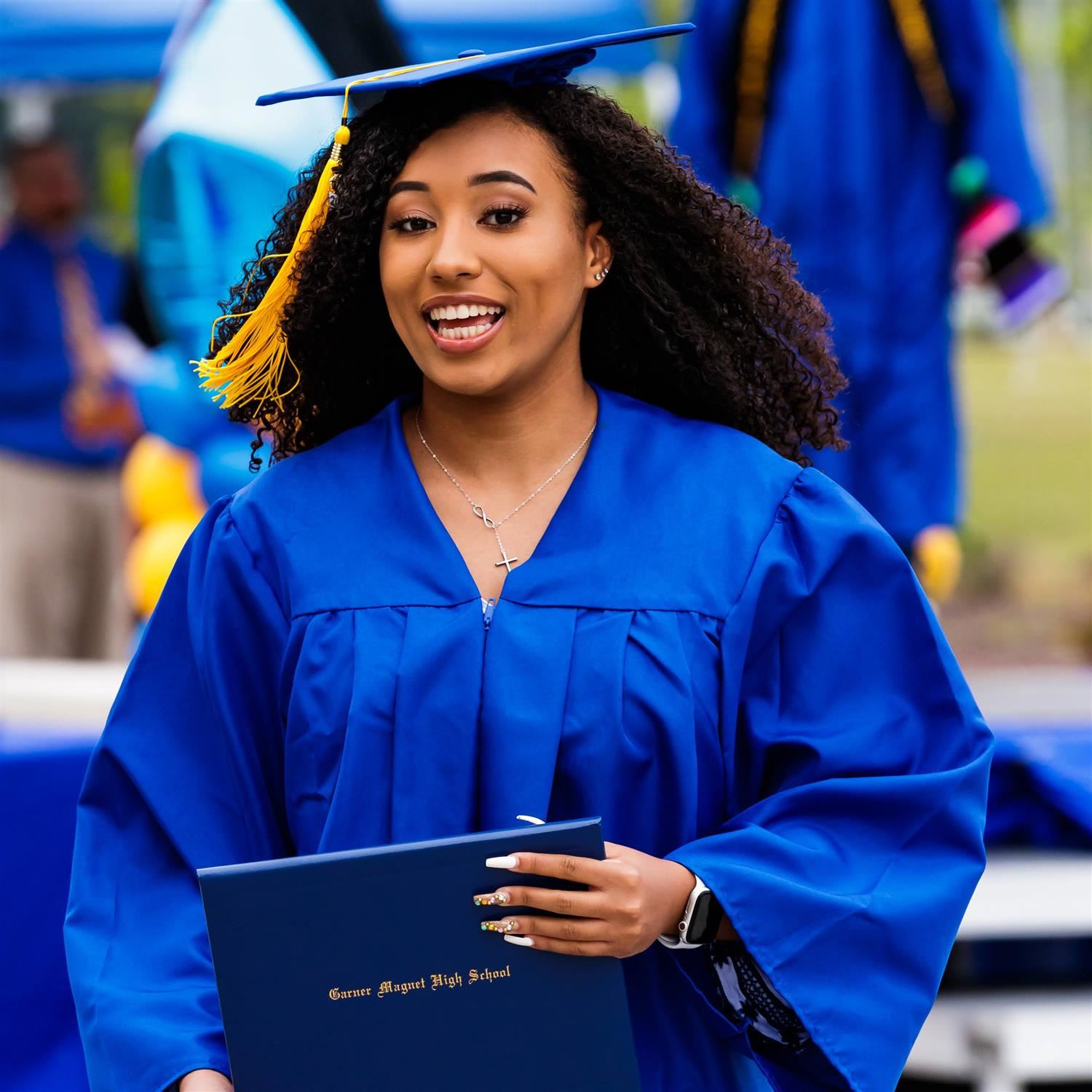  Photo of a graduate in cap and gown.