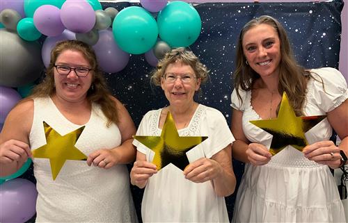 Three third grade teachers holding stars