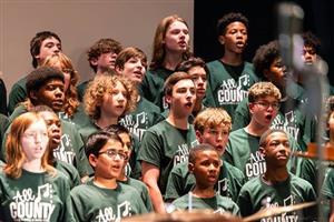 The entire choral group singing a piece during the concert