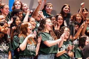 Students cheering during the chorus performance