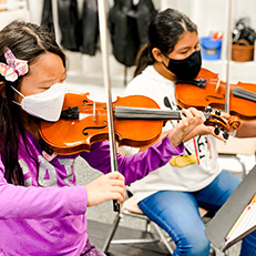  students playing violin