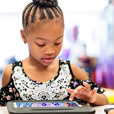  girl looking at an ipad