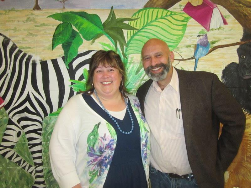 Mrs. Lay and Mr. Cohen in front of a zebra mural. Mrs. Lay and Mr. Cohen in front of a zebra mural.