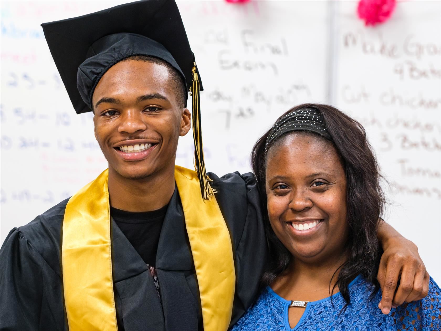 Photo of graduate Kalik Davis with his teacher Kia Bradsher.