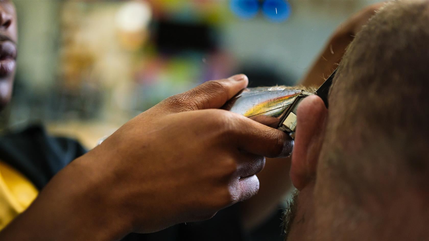Photo of Kalik giving a haircut.