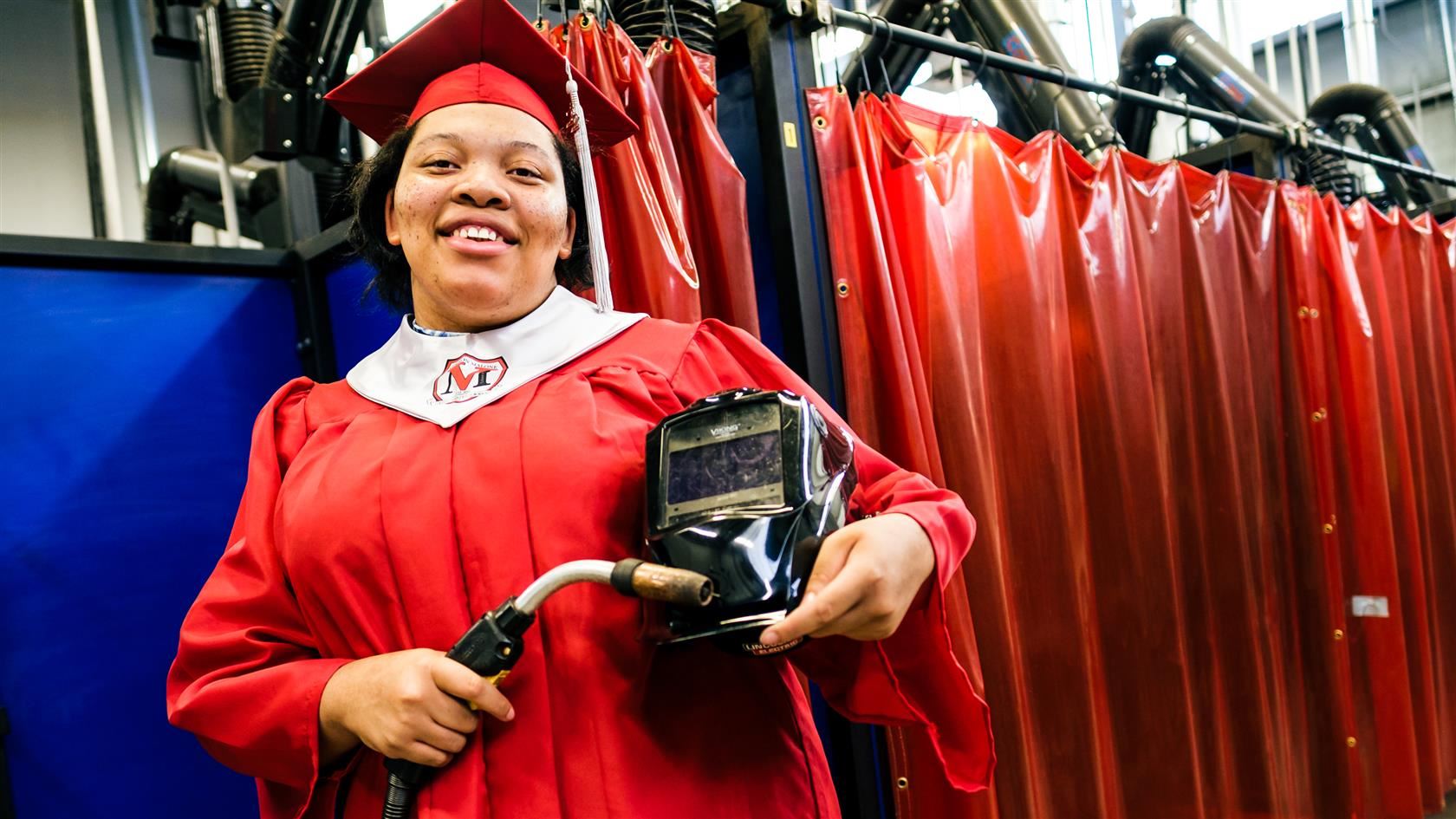 princess beckwith with cap and gown and welding equipment