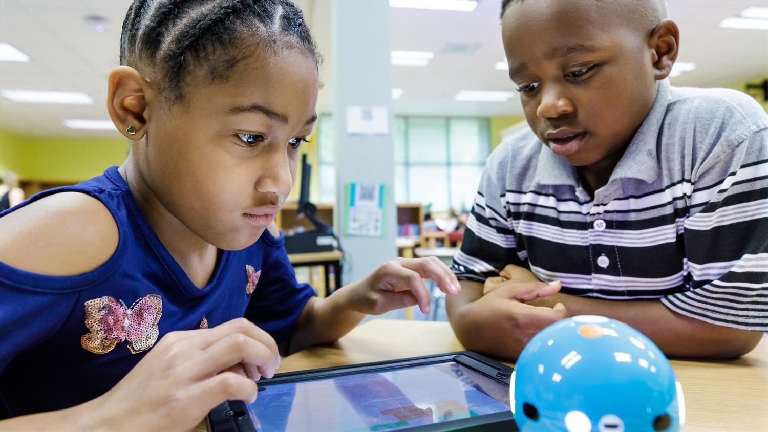 Bugg Elementary students working with a robot 